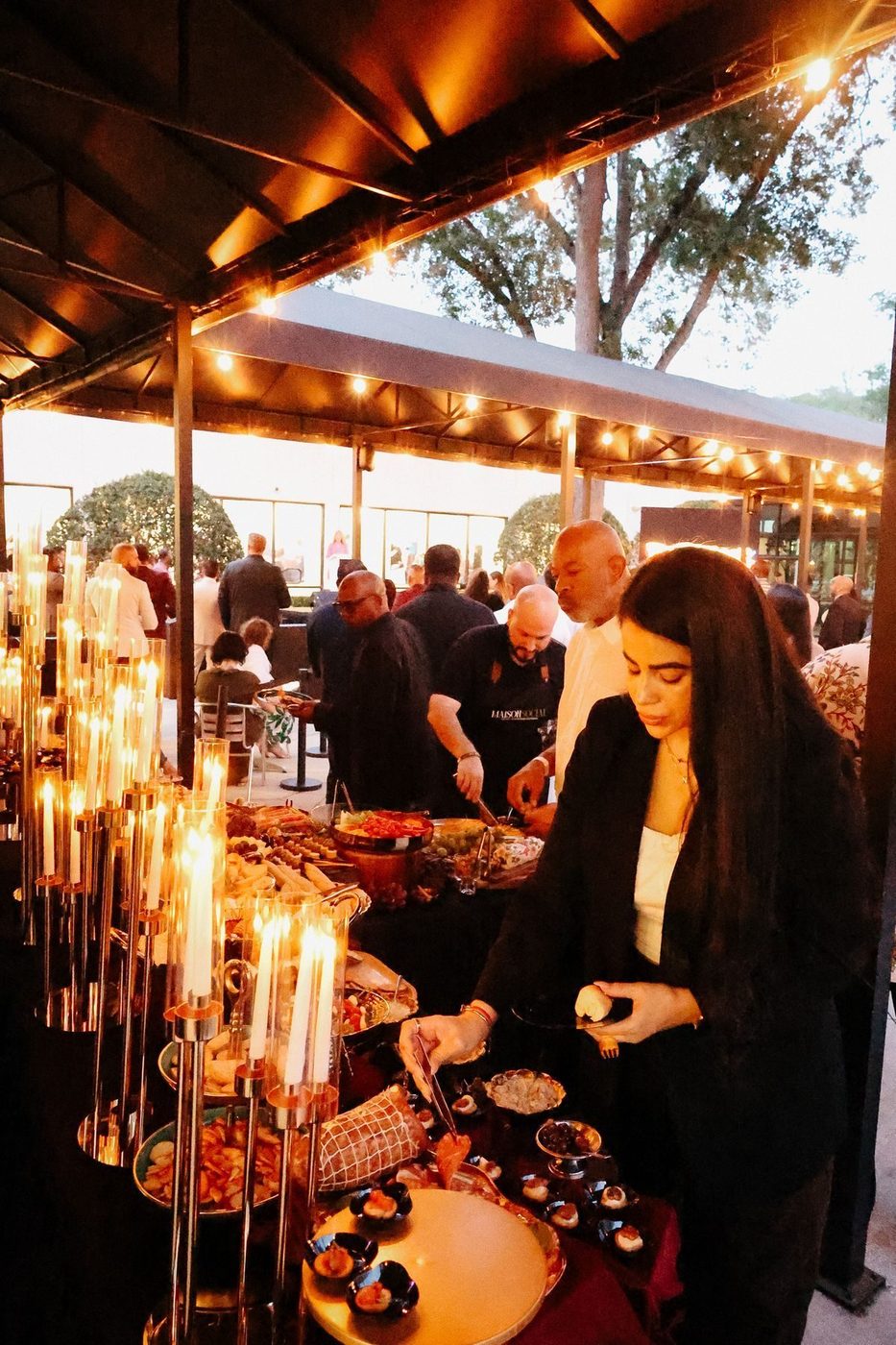 Candlelit outdoor buffet with guests
