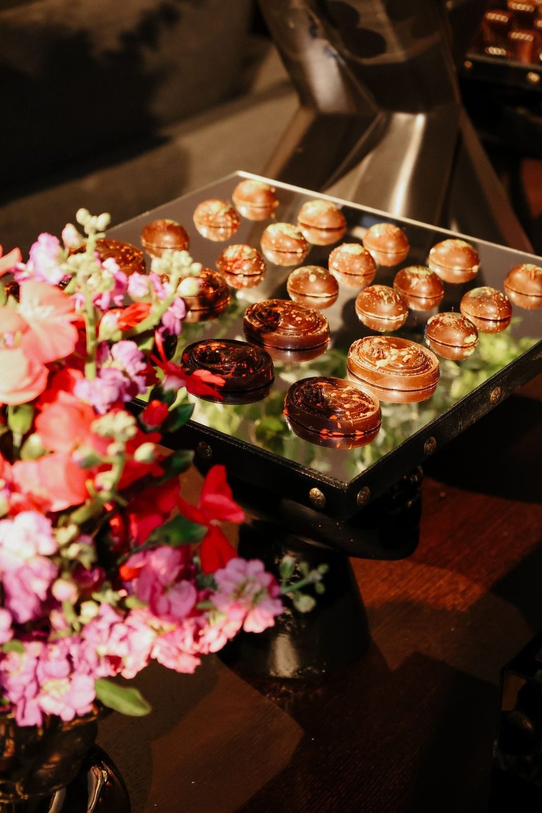 Canapes on a mirrored tray with blossoms