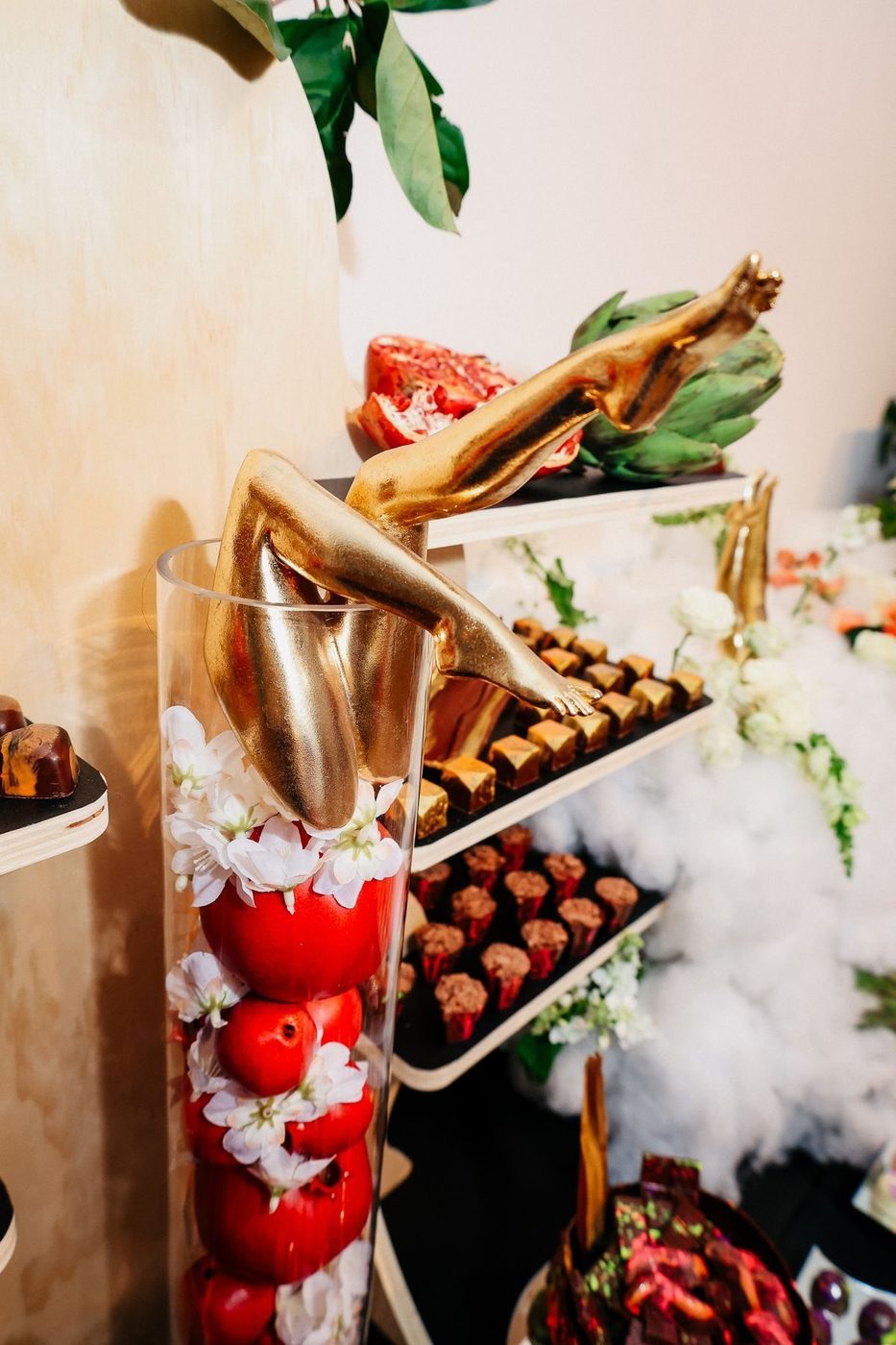Dessert shelves with chocolates and pomegranate