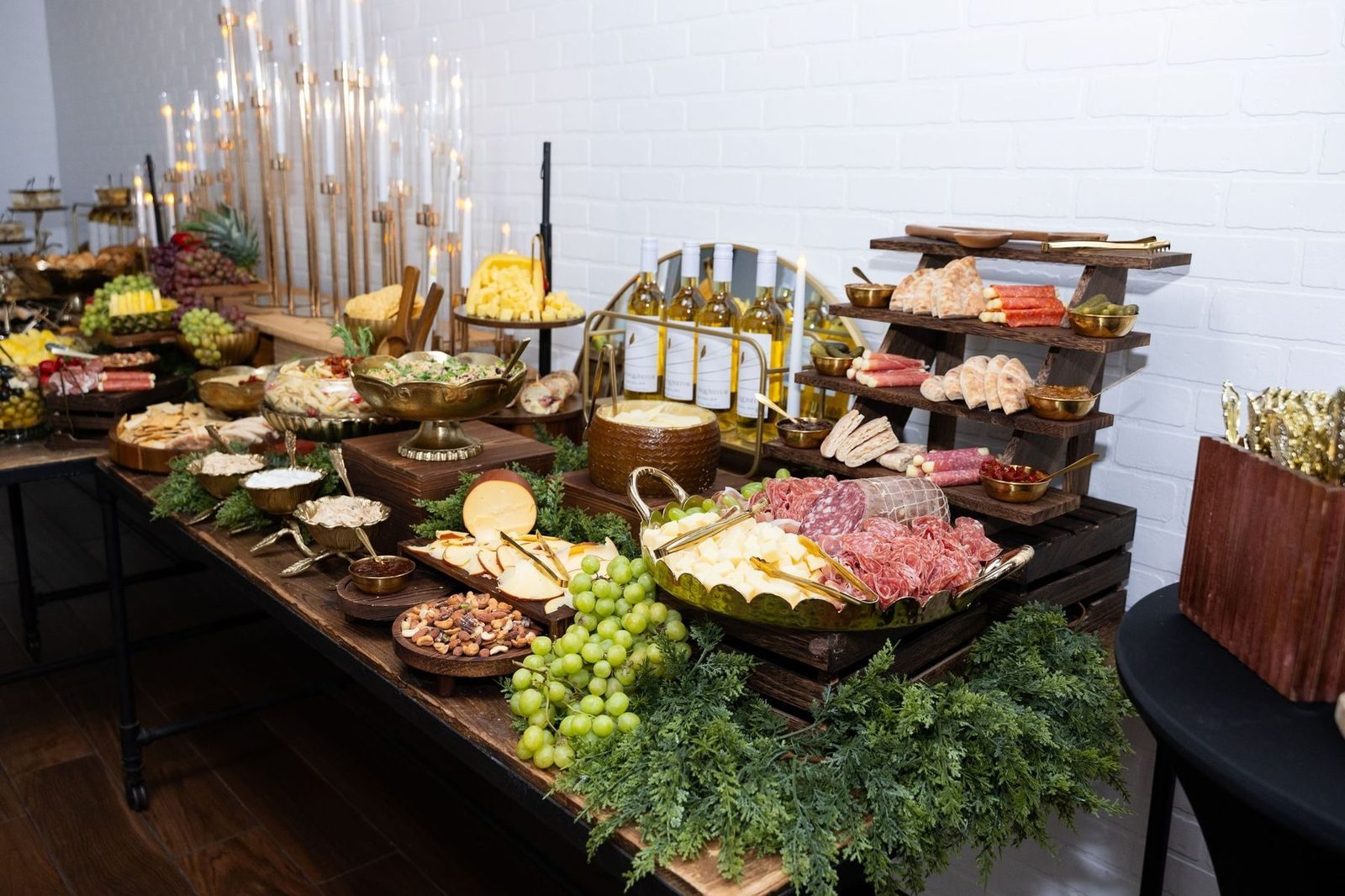 Charcuterie, cheeses and wine on a tiered table
